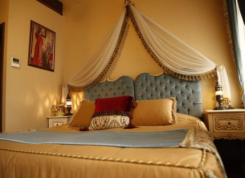 Elif Hatun Konagi Tarsus guest room with ornate bed and draped canopy