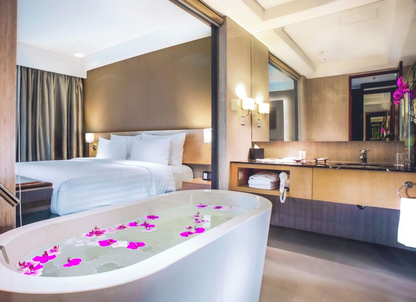 JS Luwansa Hotel And Convention Center Jakarta suite with freestanding tub and king bed