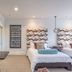 The Beaufort Inn in Beaufort bedroom with twin beds, teal tile wall, and small dining table