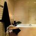 Xenia Palace Portarias bathroom with bathtub, glass shower screen, toilet, and candles in Portaria