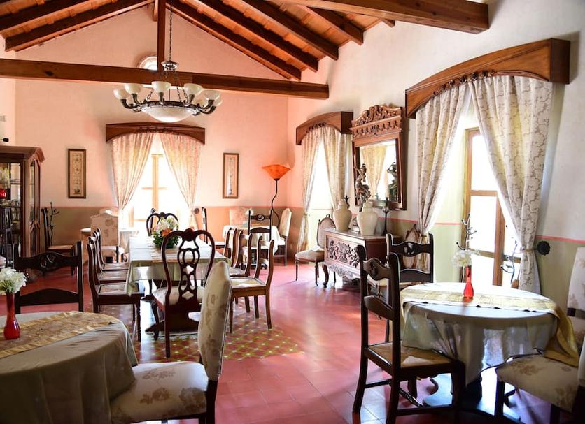 Hacienda La Magdalena Zapopan dining room with exposed beams and large windows
