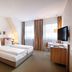 Hotel am Jakobsmarkt Nuremberg guest room with twin beds, desk, TV and window light