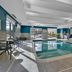 Hampton Inn Buffalo - Amherst indoor pool with lounge chairs and large windows in Amherst