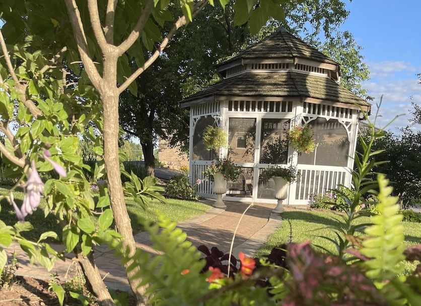 Cloran Mansion Bed & Breakfast in Galena, garden path leading to a white gazebo-style pavilion