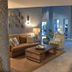 Pelican Beach Resort & Conference Center lobby in Destin with sofa, armchair, coffee table and tiled floors