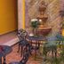 Maya Campeche Hotel in Campeche courtyard seating with wrought-iron tables, chairs, fountain and plants