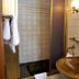 Salzufler Hof bathroom with bronze sink, round mirror, shower and towel rack in Bad Salzuflen