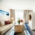 Best Western Plus Welcome Hotel Frankfurt guest room with sofa, bed, and striped carpet in Frankfurt am Main