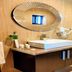 The Cabin Hotel in Accra bathroom with sink vanity, mirror, and glass walk-in shower