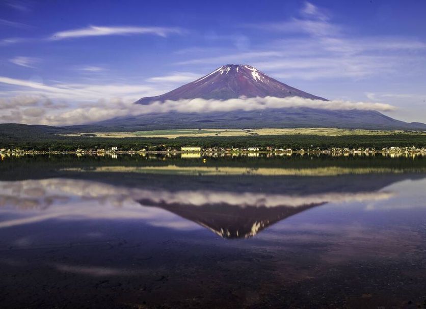 Haostay in Fujikawaguchiko with Mount Fuji reflected in a calm lake under a clear sky