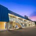 Days Inn by Wyndham Harrisonburg exterior at dusk with blue roof and lit staircase in Harrisonburg