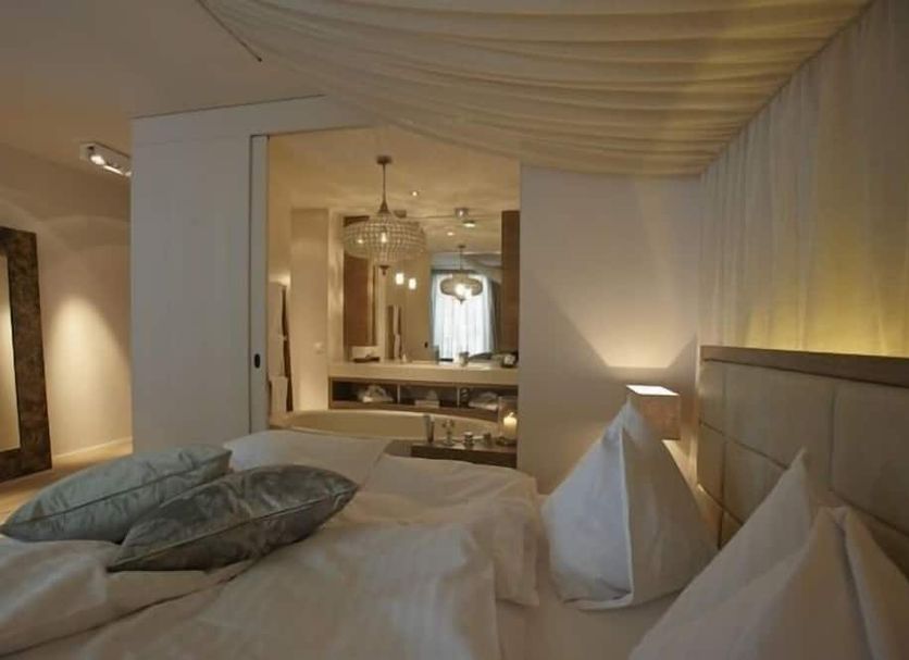 Bad Bubendorf Design & Lifestyle Hotel Bubendorf guest room with bed and mirrored vanity