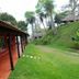 Rio Arriba Suites Apartments y Resto in Bella Vista, hillside hotel walkway with red rooms and tropical greenery