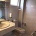 SHS Hotel Aeropuerto Madrid bathroom with sink, toilet, shower and tiled walls