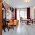 Royal Gdansk hotel room in Gdansk with seating area, large window, desk, and wardrobe
