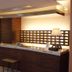 Center Hotel Toyota lobby front desk with wood paneling and a floor lamp