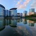 Wuxi Idea Garden Hotel in Wuxi with modern glass towers reflected in a calm lake at sunset