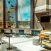 Delta Hotels by Marriott Olbia Sardinia lounge with bar, tall windows and potted bamboo in Olbia