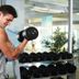 Caro Horoscop Hotel Bucharest gym with guest lifting a dumbbell