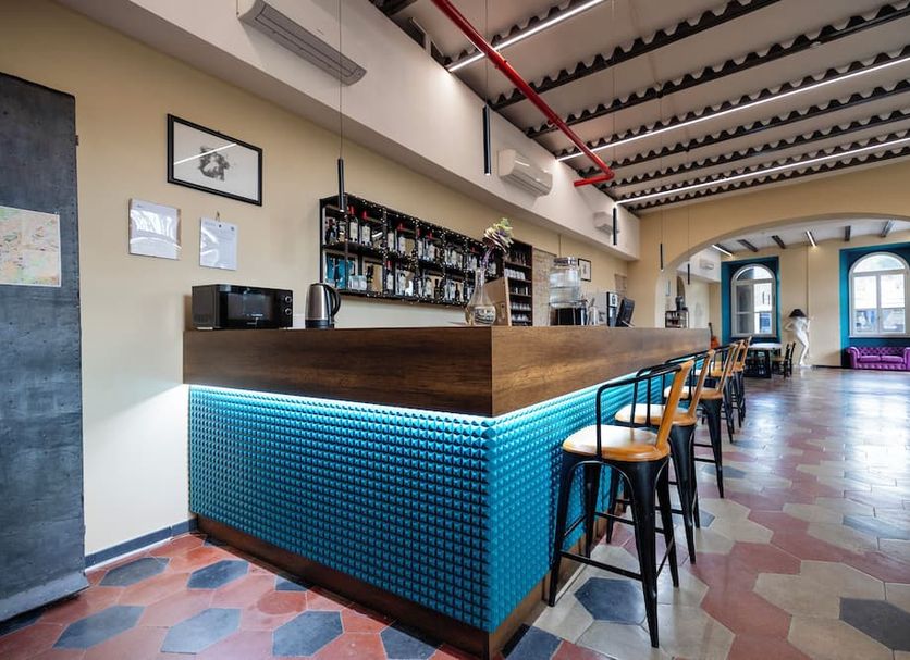 Borgo Ripa Urban Travel in Rome, hotel bar with blue-lit counter and high stools in a modern lounge