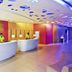 Ibis Styles Kuala Lumpur Fraser Business Park lobby with colorful ceiling and curved reception desks
