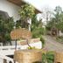 Kiriri Residence Hotel in Bujumbura outdoor patio with wicker chairs and garden pathway