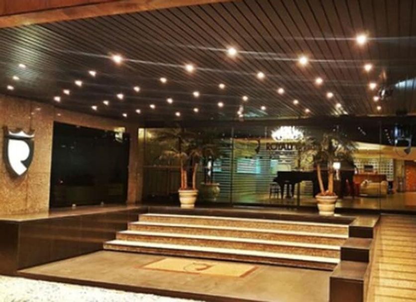 Royalty Copacabana Hotel Rio de Janeiro entrance with steps, potted palms, and modern ceiling lights
