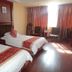 Jinluowan Hotel Ji'an guest room with two beds, curtains, and bright window light