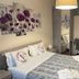 Villa Mase in Ravenna guest room with king bed, floral wall art, desk, and hardwood floor