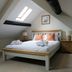 The Frocester, Stroud: attic bedroom with skylight, double bed, and bedside tables