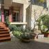 Milano Ostello in Milan with a terracotta stairway and potted plants at the entrance
