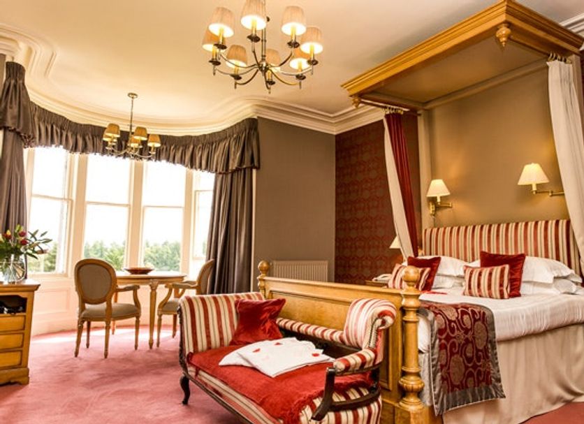 Loch Ness Country House Hotel, Inverness: elegant four-poster bedroom with bay window and seating area