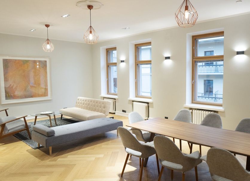 Hotel Finn Helsinki lounge with dining table, seating, artwork, and large windows