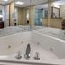 Comfort Inn & Suites Glen Mills - West Chester bathroom with corner jetted tub and mirrored vanity