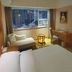 Jinghu Hotel Shenzhen guest room with large city-view window and sitting area in Shenzhen