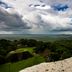 Ka'ana Resort in San Ignacio: couple embracing on a cliff overlooking lush jungle and dramatic clouds