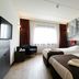 Bastion Hotel Zoetermeer guest room with two twin beds, window seat and black-and-white city mural