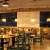Natural Lodge Caño Negro restaurant with wooden tables and pendant lights in Caño Negro