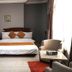Golden Key Hotel Accra room with double bed, armchair, and patterned accent wall