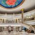 Dongguan Huaxi International Hotel lobby with grand staircase, marble floor, and ornate domed ceiling in Dongguan