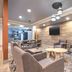 Candlewood Suites Houston (The Woodlands) By IHG lobby seating area with wall-mounted TV and wood-accent wall