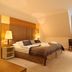 Hotel-Residence Klosterpforte in Marienfeld guest room with king bed, lamps, and window seating area