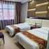 OYO Hexi Hotel in Zhangye guest room with two twin beds and large window