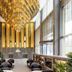 Meriton Suites Canberra lobby with grand gold chandelier, tall windows and black lounge seating in Canberra
