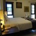 Phuket Gay Homestay in Kathu, guest room with bed, bedside lamp and open bathroom door