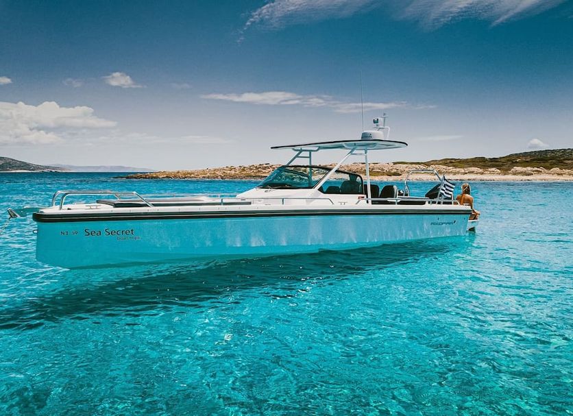 Mitos Suites in Agios Prokopios: luxury boat on clear turquoise water near the coast
