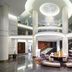 Hilton Kyiv lobby with modern circular seating, grand staircase and glass atrium in Kyiv