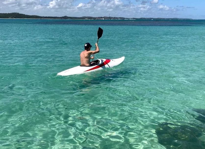 Anga Beach Hotel in São Miguel dos Milagres with a kayaker on clear turquoise water