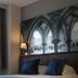 La Confiance room in Le Mont-Saint-Michel with Gothic arch wall art and twin beds