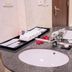 Muong Thanh Thanh Nien Vinh bathroom vanity with double sinks, towels, and potted plant in Vinh City